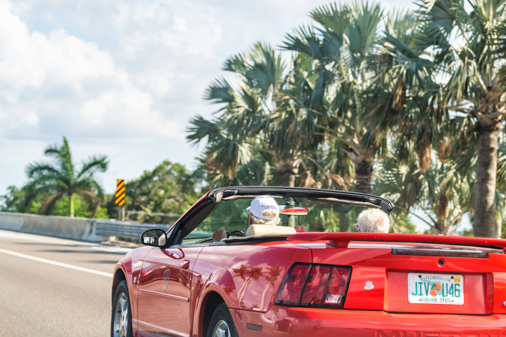 senior couple driving on a highway in Florida