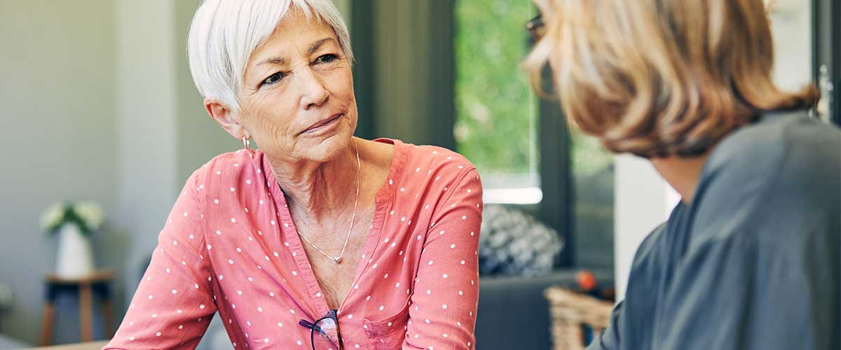 Senior woman speaking to younger woman