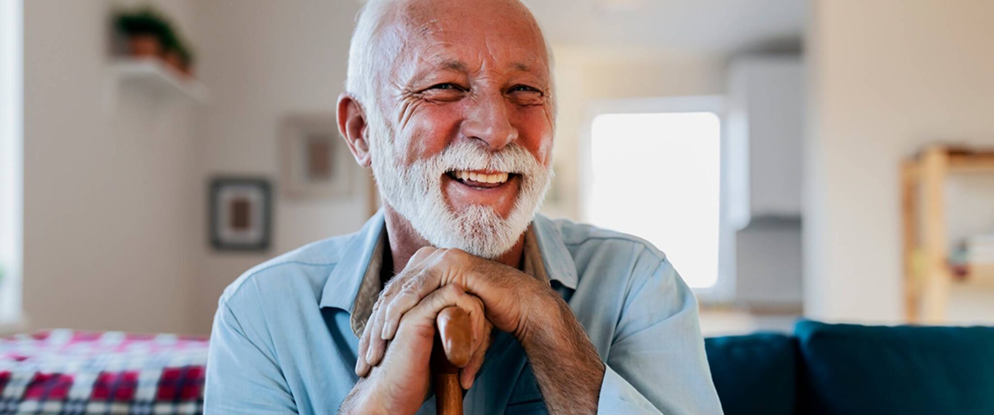 senior man smiling with his walking cane