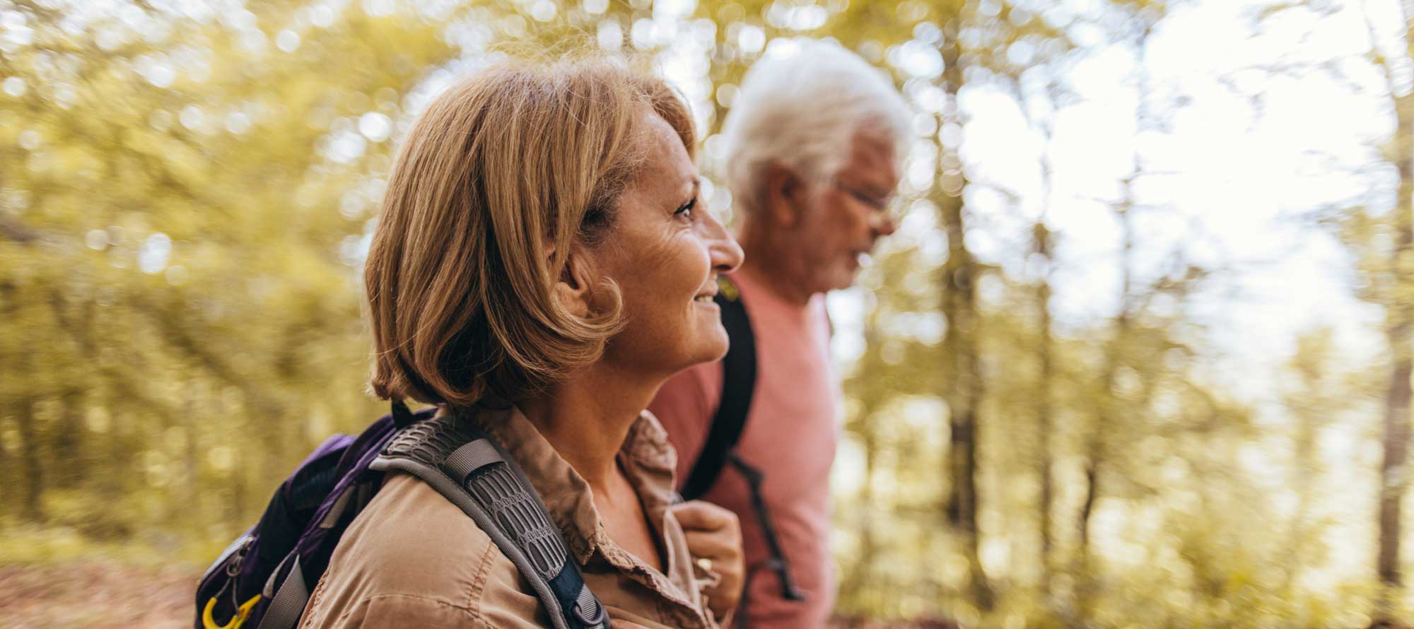 Senior couple walking through the woods