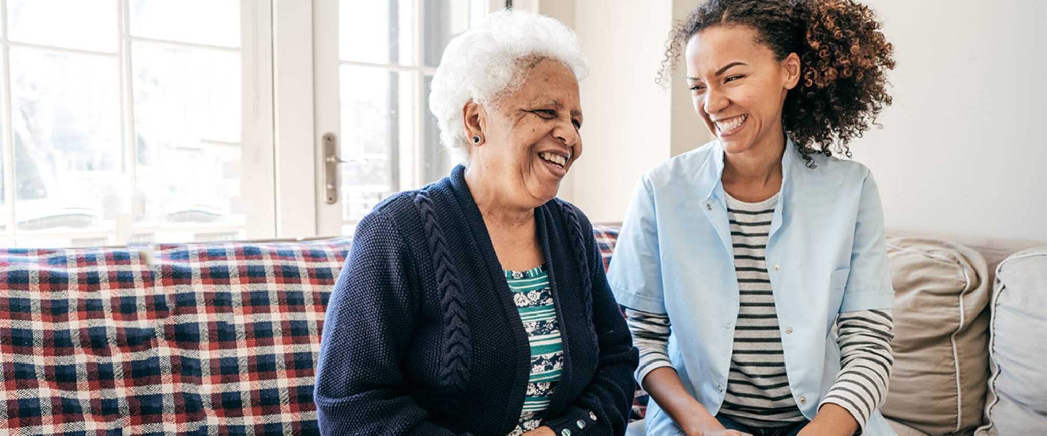 Senior woman laughing with young woman