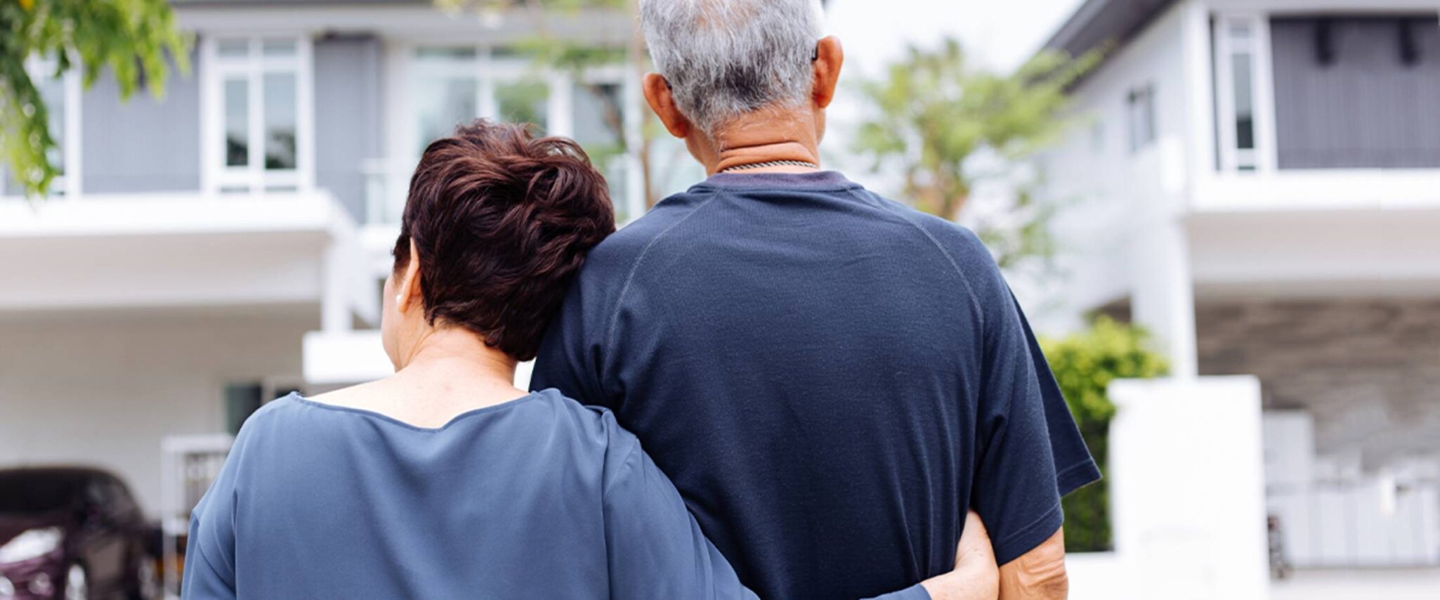 happy senior couple walking in their retirement community