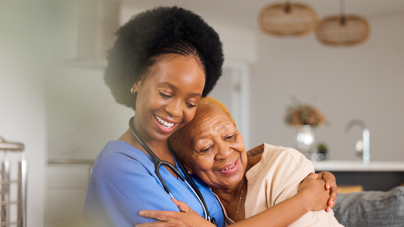 Senior woman hugging healthcare worker