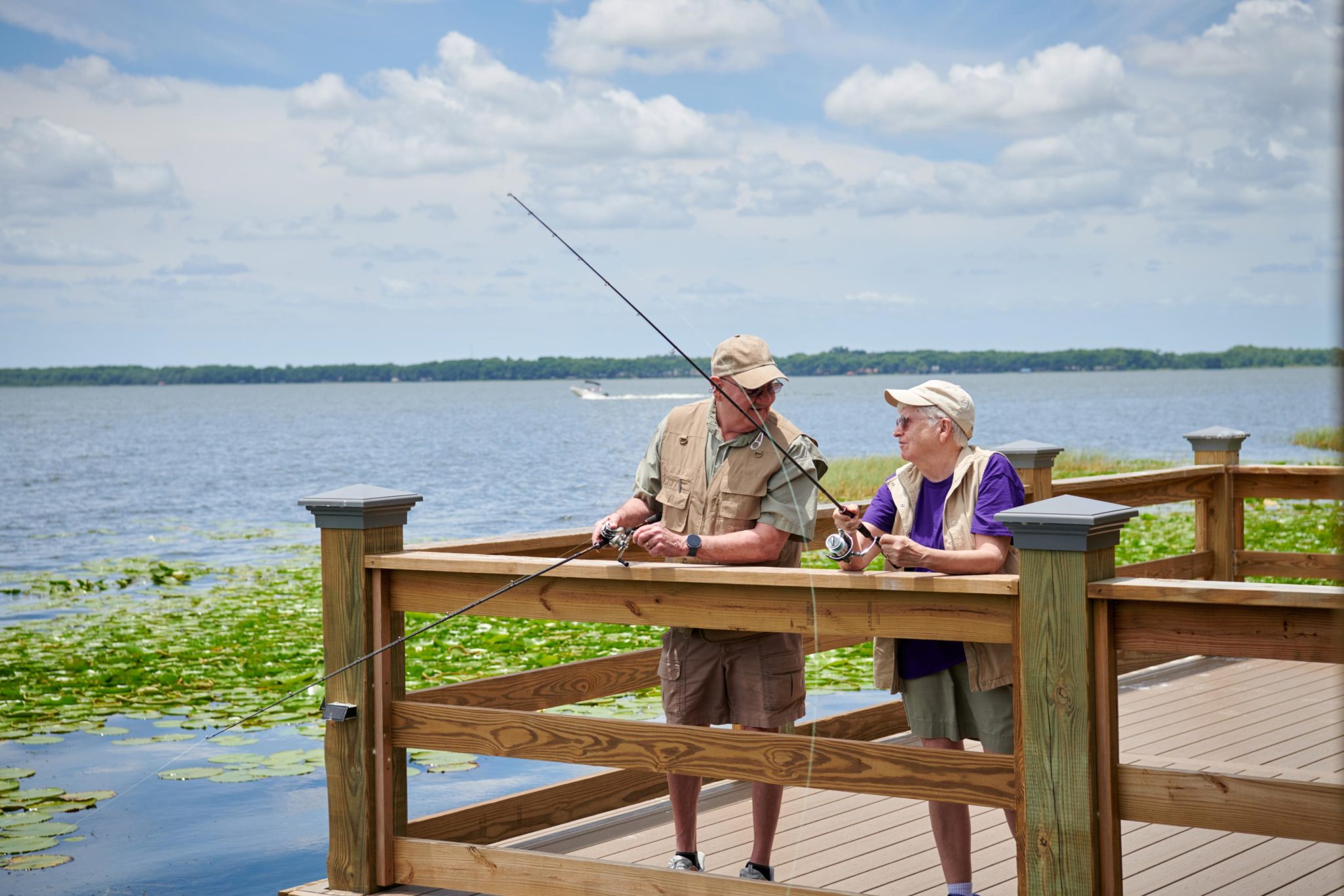 Two men fishing together at Lake Port Square