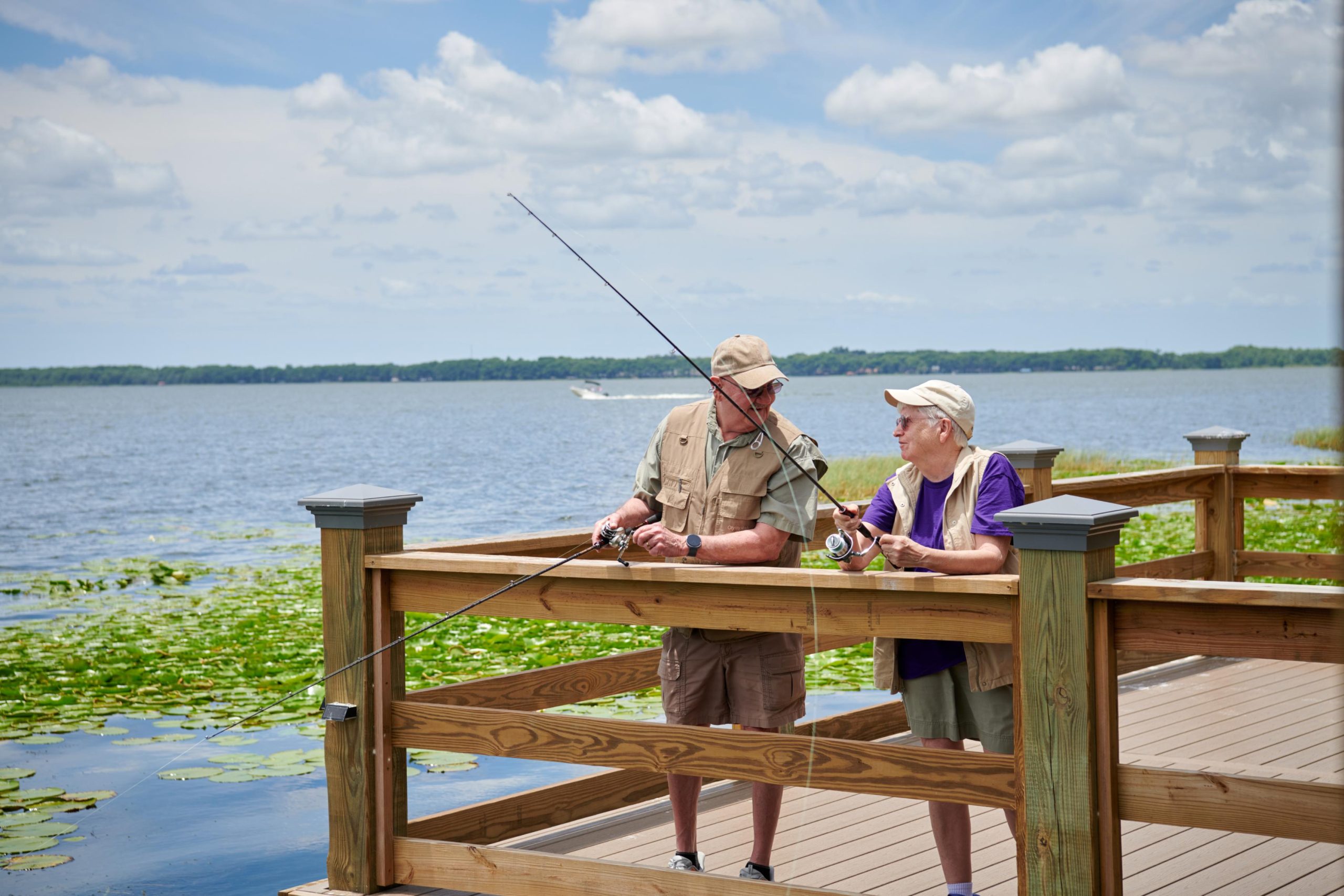 Two men fishing together at Lake Port Square