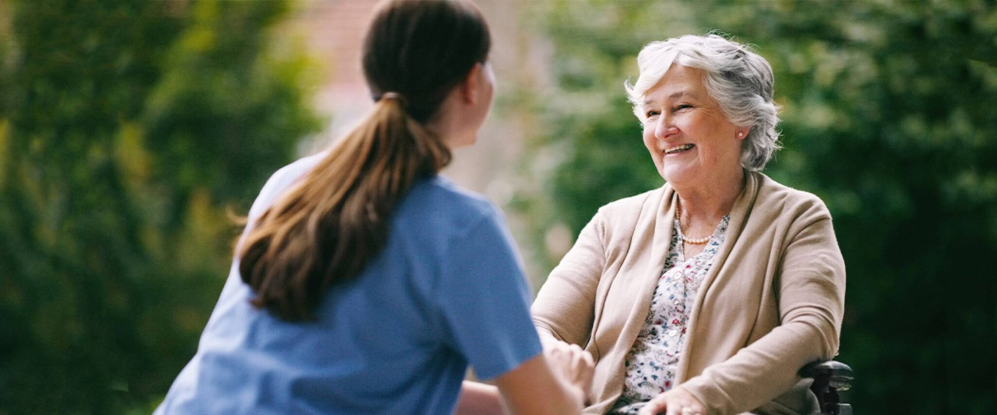 Senior woman speaking to caretaker