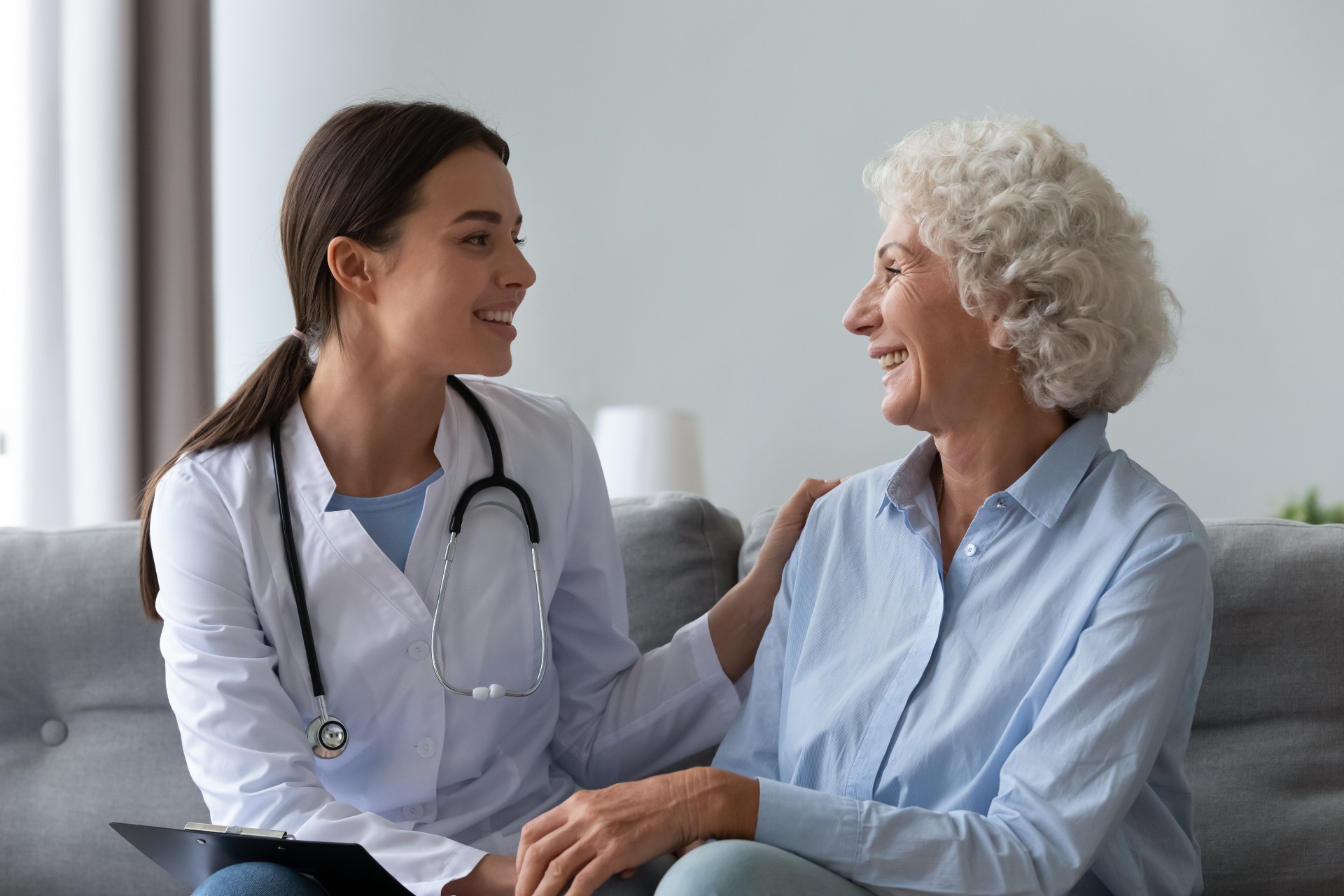 Senior woman speaking with nurse