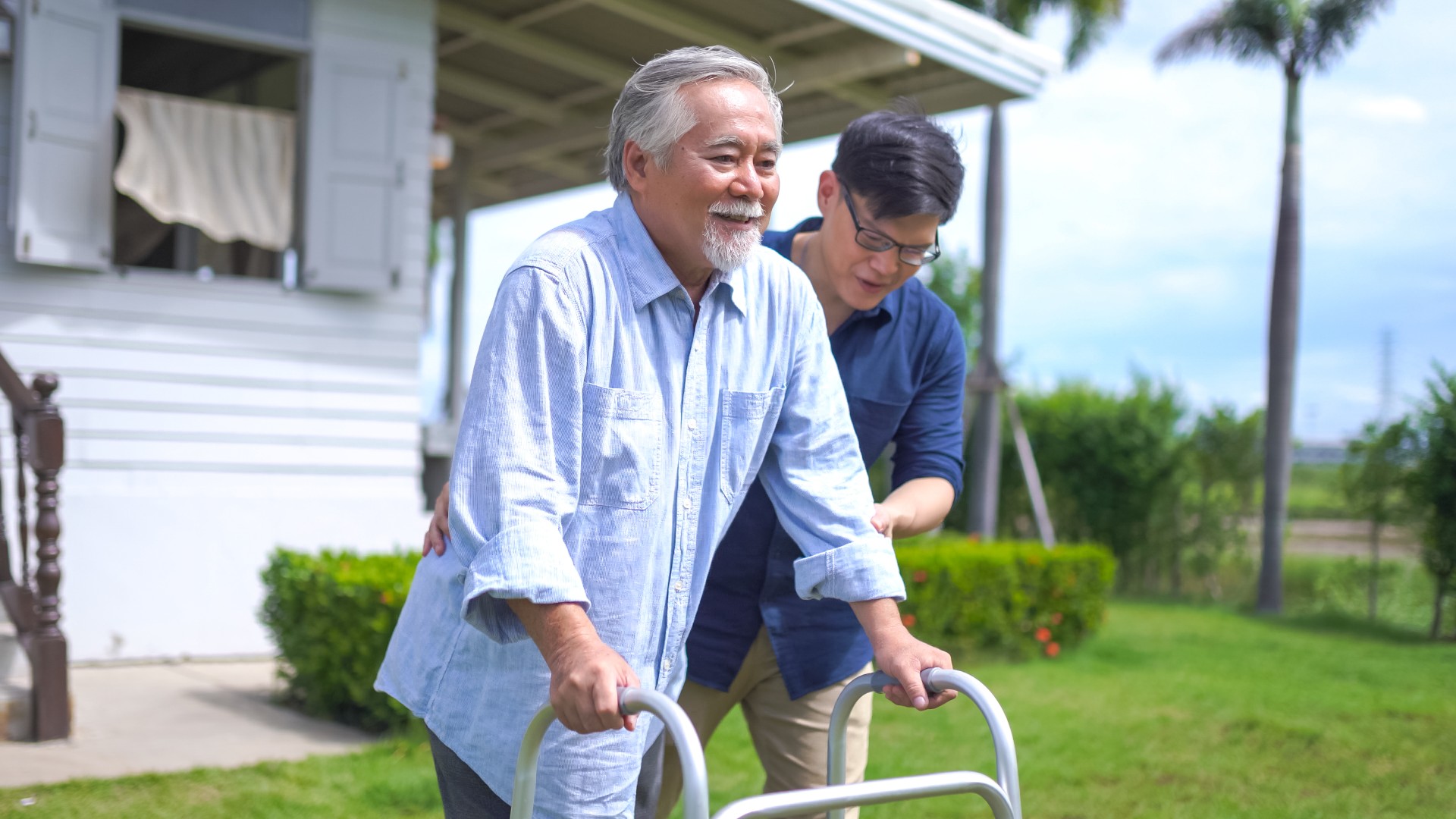 Caretaker helping senior man with walker