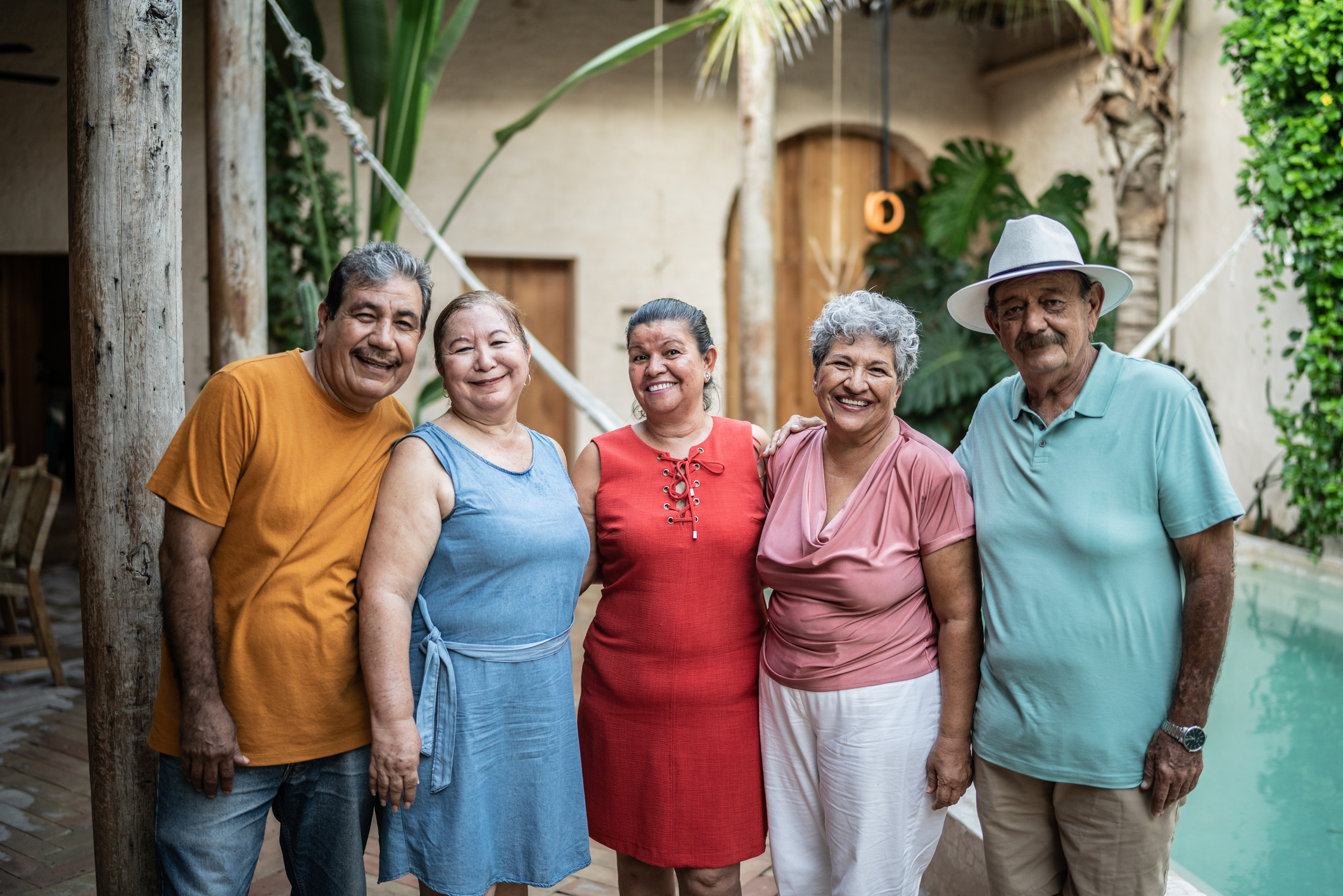 Smiling group of senior friends by pool