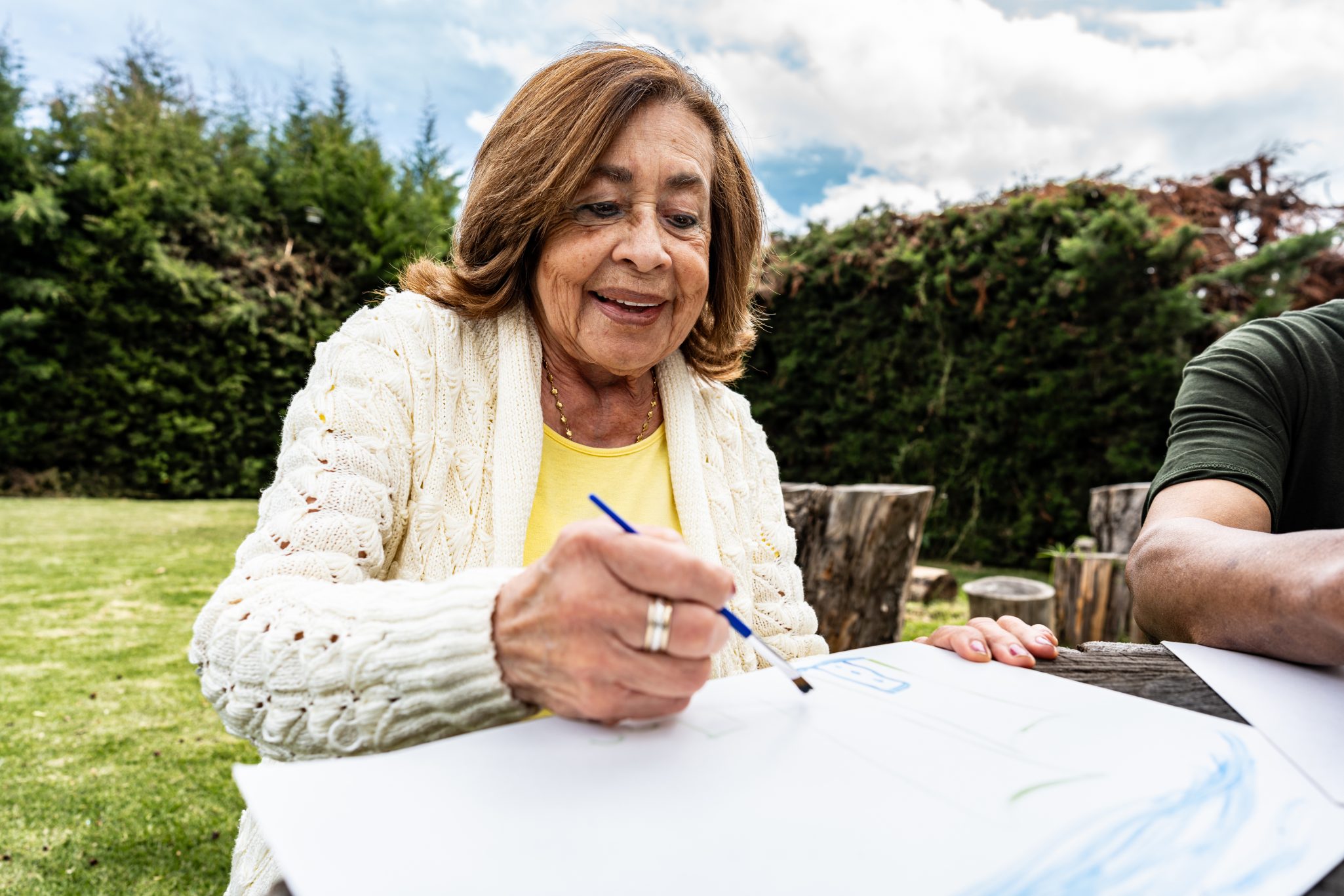 Senior woman painting outdoors