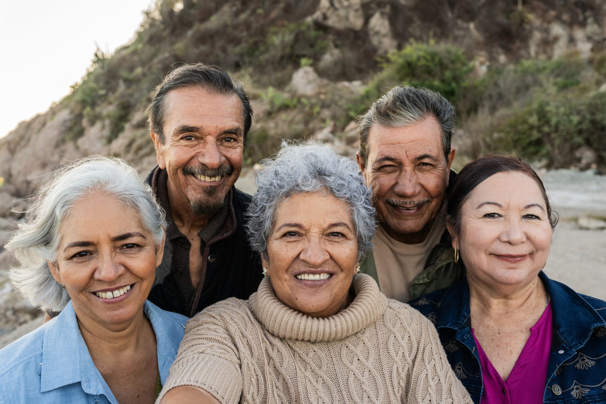 Group of seniors smiling at beach